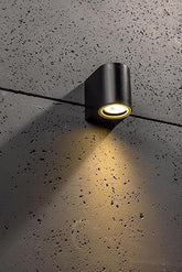 Compact IP44 wall light illuminating a hallway